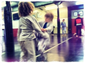 Drilling with a resisting partner in kid's martial arts class