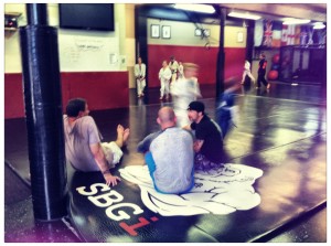 Adult coaches watching the kid's martial arts class, watching the future.