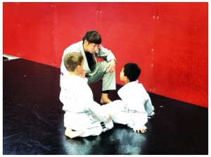Giving instruction in kid's martial arts class